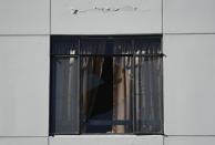 An apartment building window is broken after an overnight earthquake in Ponce, Puerto Rico, Tuesday, Jan. 7, 2020. A 6.4-magnitude earthquake struck Puerto Rico before dawn on Tuesday, killing one man, injuring others and collapsing buildings in the southern part of the island. (AP Photo/Carlos Giusti)