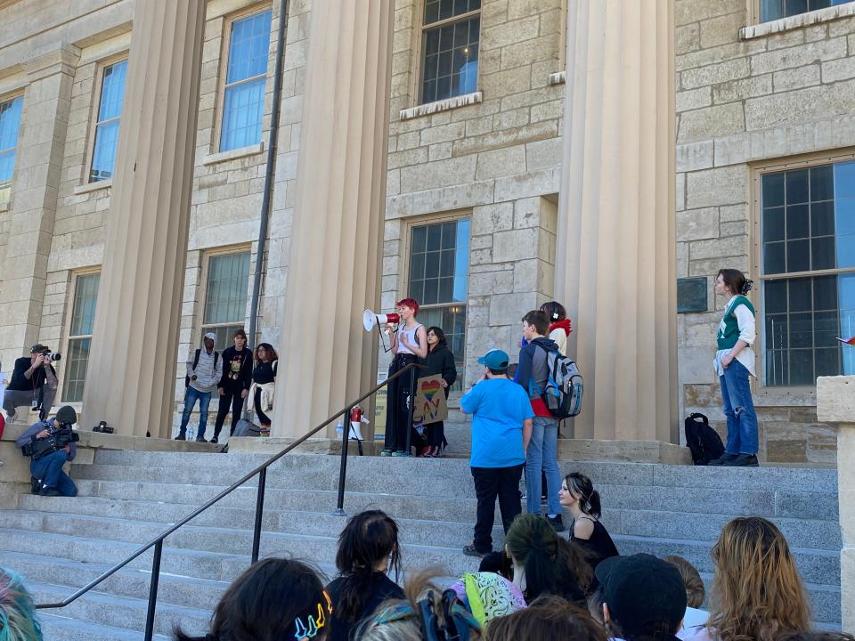 Ace Drumbarger, a transgender teen at Southeast Junior High School in Iowa City, speaks into a megaphone at a "We Say Gay" walkout and rally in Iowa City. He was one of 300 people who showed up to the Pentacrest on March 1, 2023 to protest anti-LGBTQ legislation proposed in Iowa.