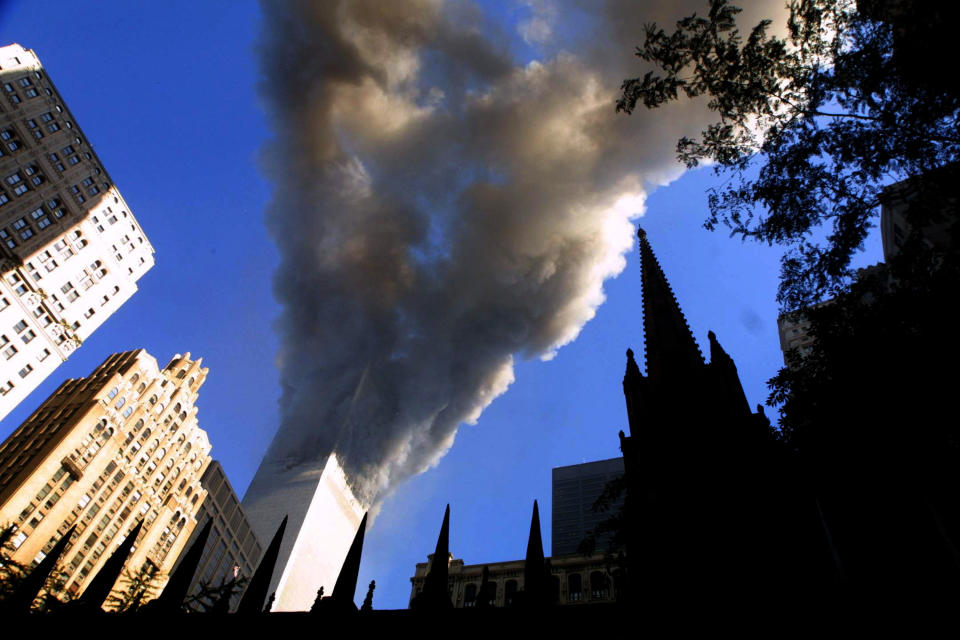 <p>Smoke spews from a tower of the World Trade Center on Sept. 11, 2001, after two hijacked airplanes hit the twin towers in a terrorist attack on New York City. (Photo: Mario Tama/Getty Images) </p>