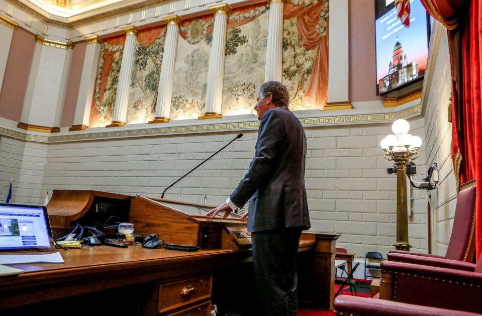 Gov. Dan McKee checks his positioning at the lectern before his State of the State address Tuesday night.