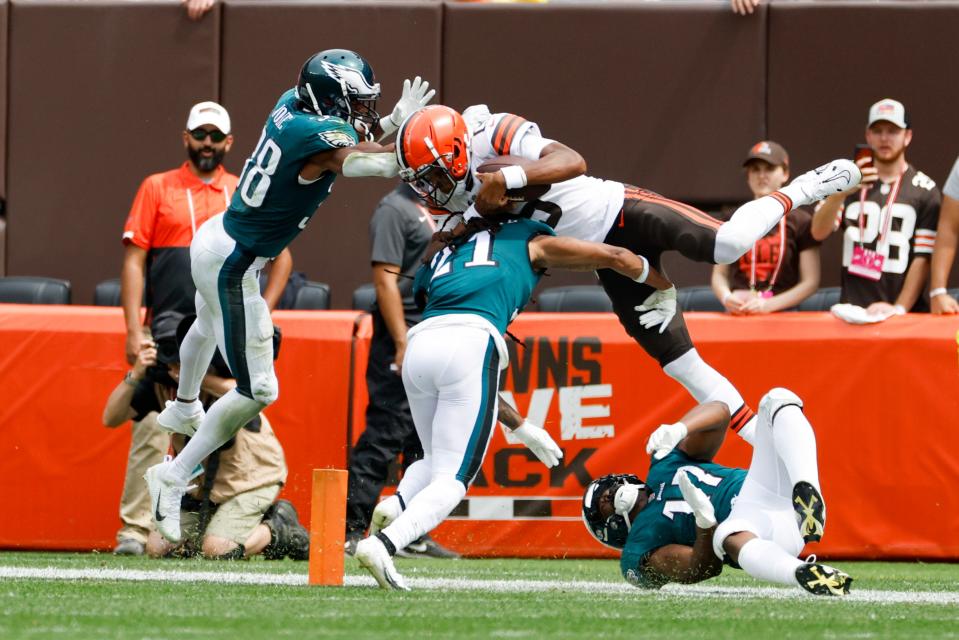 Cleveland Browns quarterback Joshua Dobbs (15) is stopped by Philadelphia Eagles safety Andre Chachere (21), linebacker Nakobe Dean (17) and cornerback Josh Jobe (38) short of a touchdown on a run during the first half of an NFL preseason football game in Cleveland, Sunday, Aug. 21, 2022. (AP Photo/Ron Schwane)