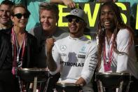 Formula One F1 - U.S. Grand Prix - Circuit of the Americas, Austin, Texas, U.S., 23/10/16. Race-winning Mercedes driver Lewis Hamilton of Britain celebrates tennis star Venus Williams (R), chef Gordon Ramsay and actress Noomi Rapace (L) after the race. REUTERS/Adrees Latif