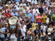 Britain Tennis - Wimbledon - All England Lawn Tennis & Croquet Club, Wimbledon, England - 9/7/16 USA's Serena Williams celebrates winning her womens singles final match against Germany's Angelique Kerber with the trophy REUTERS/Toby Melville