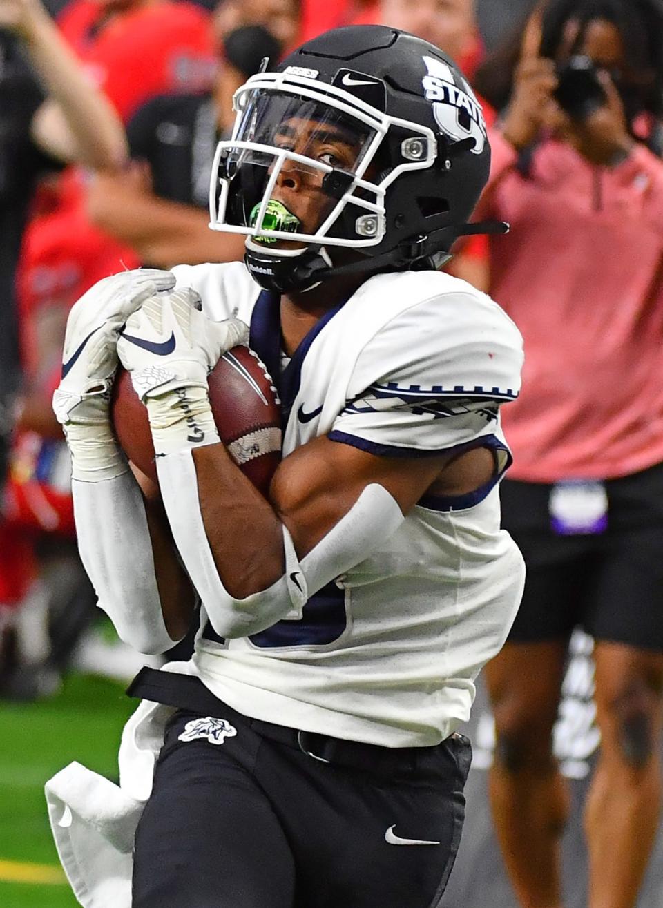 Oct 16, 2021; Paradise, Nevada, USA;  Utah State Aggies wide receiver Deven Thompkins (13) eyes the end zone after making a 37-yard reception against the UNLV Rebels at Allegiant Stadium. Mandatory Credit: Stephen R. Sylvanie-USA TODAY Sports