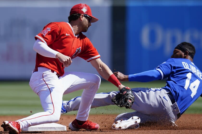 Kansas City Royals' Edward Oliveras (14) steals second base as Los Angeles Angels shortstop Tyler Wade.