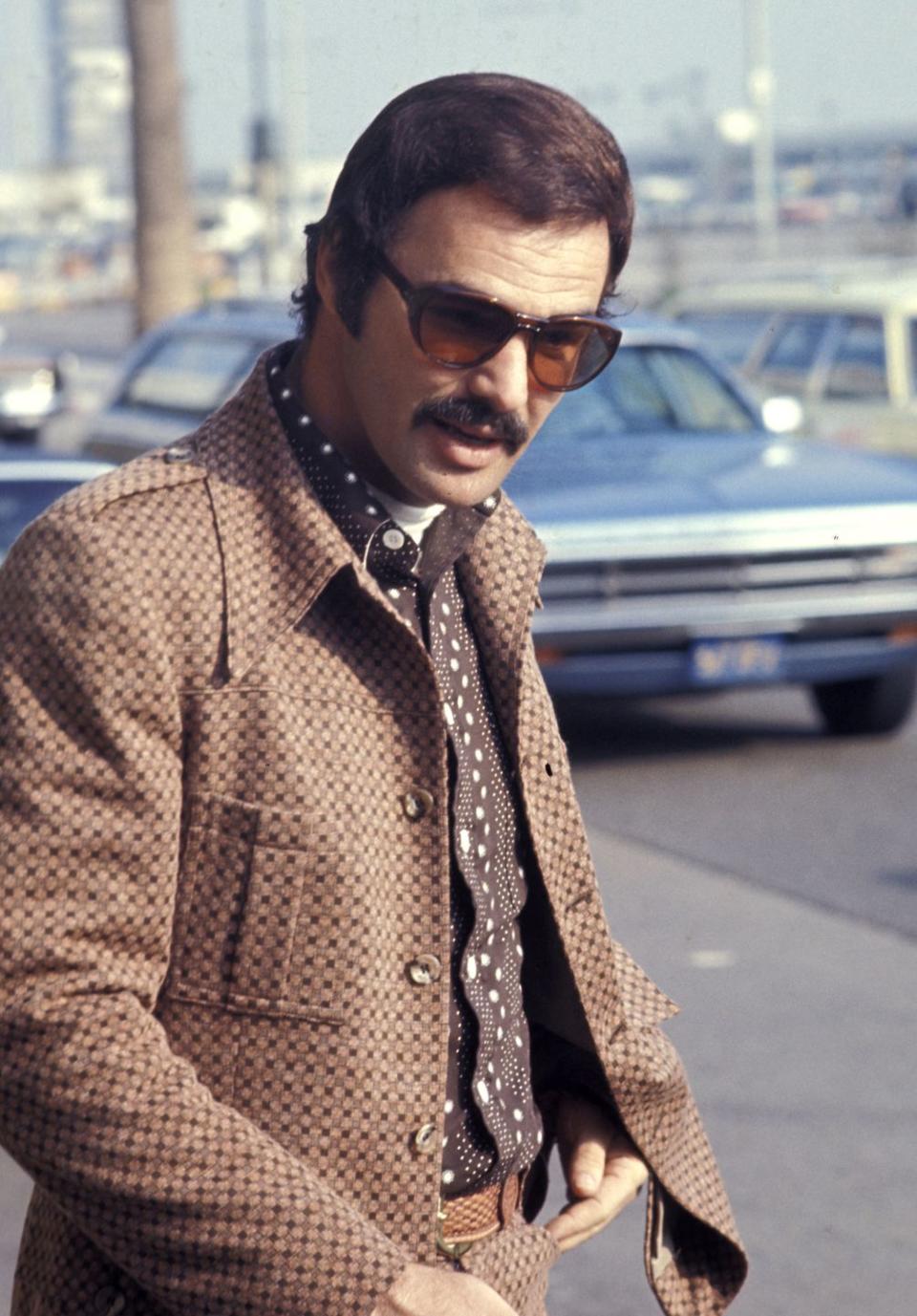 <p>Reynolds outside LAX after arriving from Miami in 1972. The sunglasses, shirt, and jacket are incredible, but look closer and notice that he's wearing a white turtleneck under it all. Gutsy—and ahead of his time. </p>