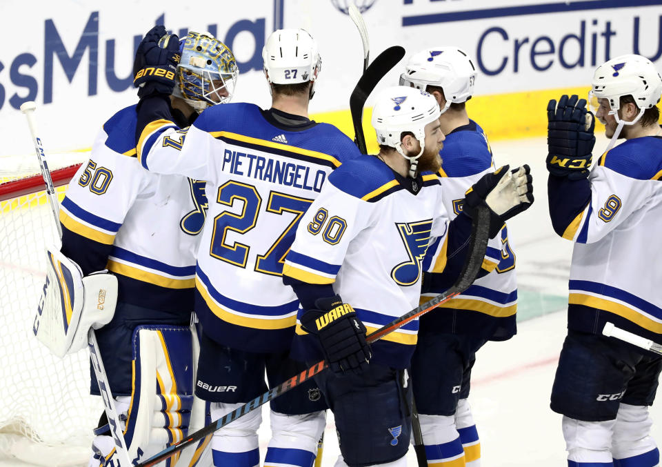 St. Louis Blues goaltender Jordan Binnington (50) celebrates with Alex Pietrangelo (27), Ryan O'Reilly (90), David Perron, center rear, and Sammy Blais (9), following the team's 4-1 win against the Dallas Stars in Game 6 of an NHL second-round hockey playoff series in Dallas, Sunday, May 5, 2019. (AP Photo/Tony Gutierrez)