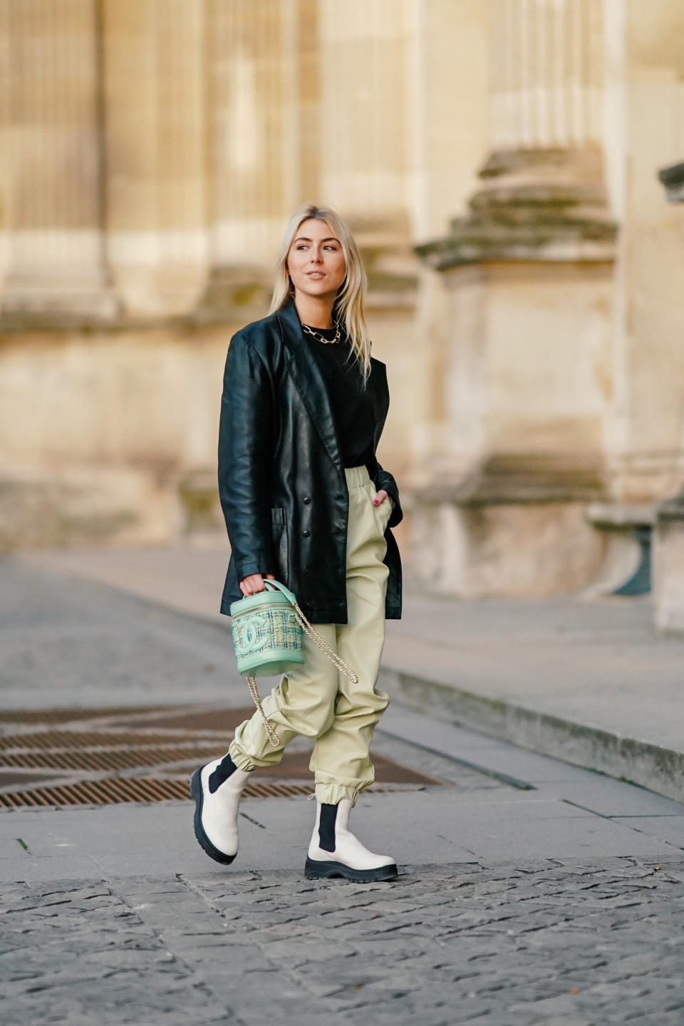 PARIS, FRANCE - NOVEMBER 24: Emma Bonneaud wears a golden chain necklace, a black leather oversized vintage jacket from Azzedine Alaia, a black pullover, pale green leather pants from Frankie Shop, a green Chanel bag made of leather and tweed, black and white boots from H&M, on November 24, 2020 in Paris, France. (Photo by Edward Berthelot/Getty Images)