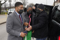 Actor Jussie Smollett, left, arrives with his mother Janet, center, with the aid of a bodyguard at the Leighton Criminal Courthouse for day three of his trial in Chicago on Wednesday, Dec. 1, 2021. Smollett is accused of lying to police when he reported he was the victim of a racist, anti-gay attack in downtown Chicago nearly three years ago. (AP Photo/Charles Rex Arbogast)