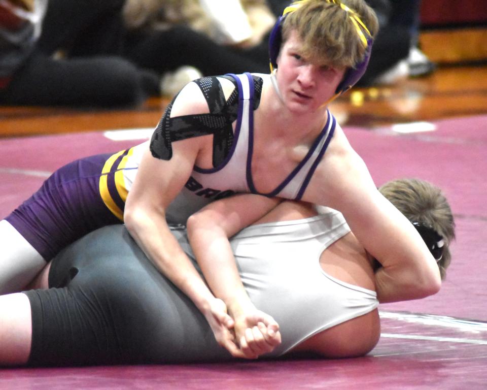 Bronson's Logan Long gets some advice from his coaches during his pin fall win versus Homer Wednesday night