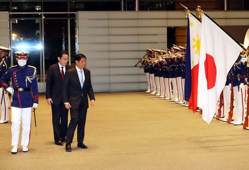 Philippine President Marcos Jr. and Japanese Prime Minister Kishida listen to their national anthems at the prime minister's official residence in Tokyo