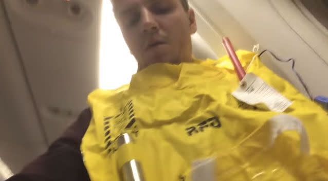 Williams and fellow passengers threw on their yellow life jackets as they prepared for a water landing. Source: YouTube