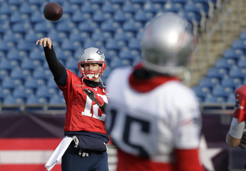 New England Patriots quarterback Tom Brady, left, and wide receiver Chris Hogan, center, warm up during NFL football practice, Thursday, Dec. 20, 2018, in Foxborough, Mass. (AP Photo/Steven Senne)