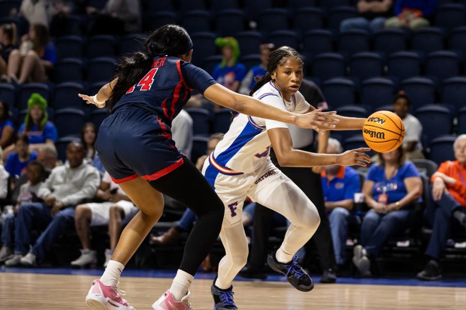 Florida Gators guard Laila Reynolds (13) drives to the basket against St. John's Red Storm forward Jillian Archer (14) during the first half at Billy Donovan Court at Stephen C. O'Connell Center in Gainesville, FL on Thursday, March 21, 2024. [Matt Pendleton/Gainesville Sun]