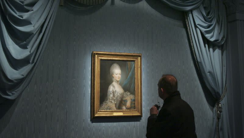 A member of the media views a portrait of Marie-Antoinette by French artist Joseph Ducreux as he visits the Marie Antoinette exhibition at the Grand Palais museum in Paris on March 13, 2008.