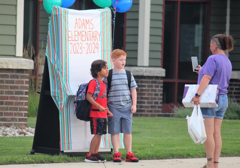 Students stand for a picture at Zeeland's Adams Elementary on the first day of school Tuesday, Aug. 29.