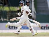 India's Stuart Binny (L) and Naman Ojha run between wickets during the fourth day of their third and final test cricket match against Sri Lanka in Colombo August 31, 2015. REUTERS/Dinuka Liyanawatte