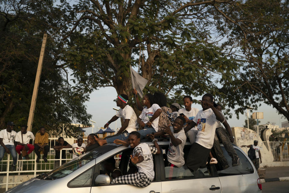 Supporters of the Gambian President Adama Barrow celebrate the partial results that give the lead to their candidate during the counting ballots in Gambia's presidential election, in Banjul, Gambia, Sunday, Dec. 5, 2021. Election officials in the West African nation of Gambia have started counting marble votes after polls closed for the first presidential election in decades that does not include former dictator Yahya Jammeh as a candidate. (AP Photo/Leo Correa)