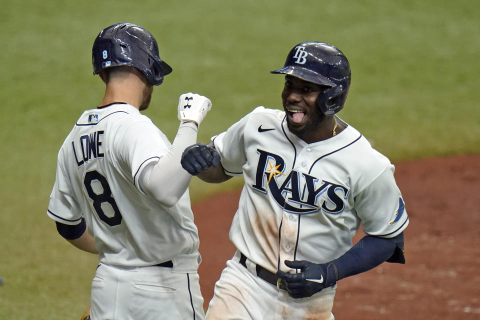 Tampa Bay Rays' Randy Arozarena celebrates his solo home run off New York Yankees starting pitcher Domingo German with second baseman Brandon Lowe (8) during the third inning of a baseball game Saturday, April 10, 2021, in St. Petersburg, Fla. (AP Photo/Chris O'Meara)