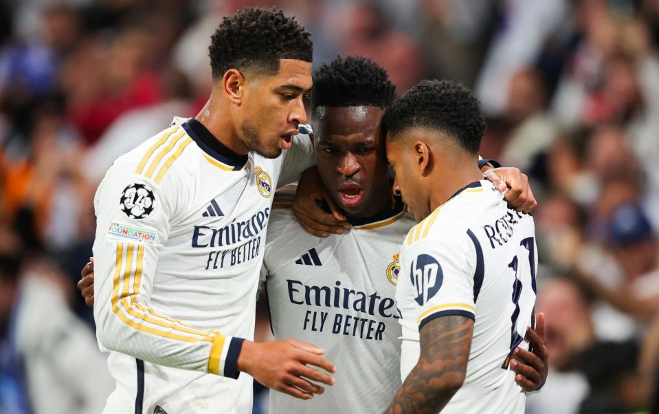 Real Madrid's Rodrygo celebrates with Jude Bellingham and Vinicius Jr.  after scoring his side's second goal during the UEFA Champions League quarter-final first leg between Real Madrid CF and Manchester City at Estadio Santiago Bernabeu on April 9, 2024 in Madrid, Spain