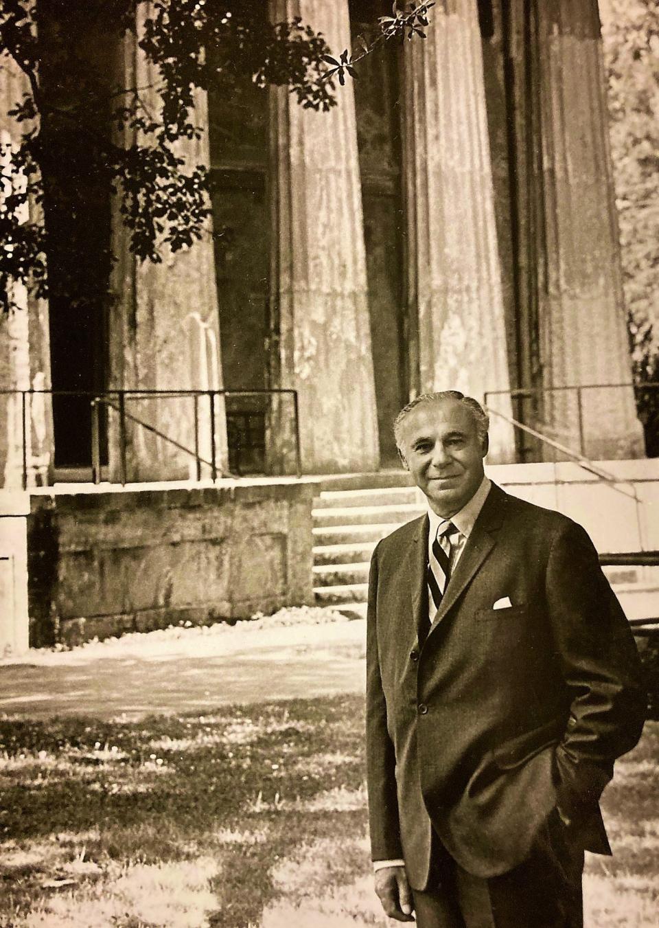 Dr. Robert Greenblatt poses in front of the old Medical College Building