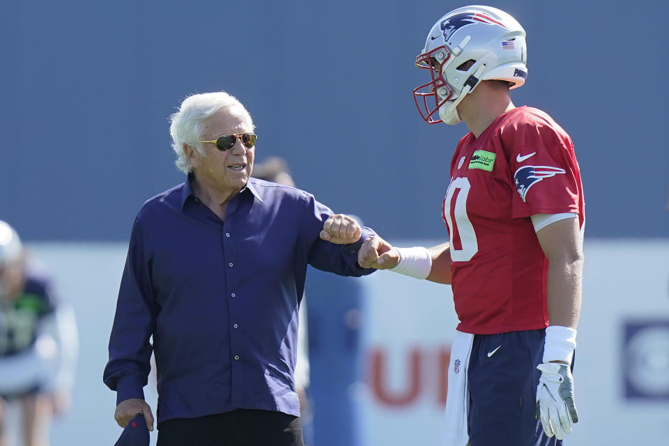 New England Patriots owner Robert Kraft, left, speaks with quarterback Mac Jones, right, during the NFL football team's training camp, Wednesday, Aug. 3, 2022, in Foxborough, Mass. (AP Photo/Steven Senne)