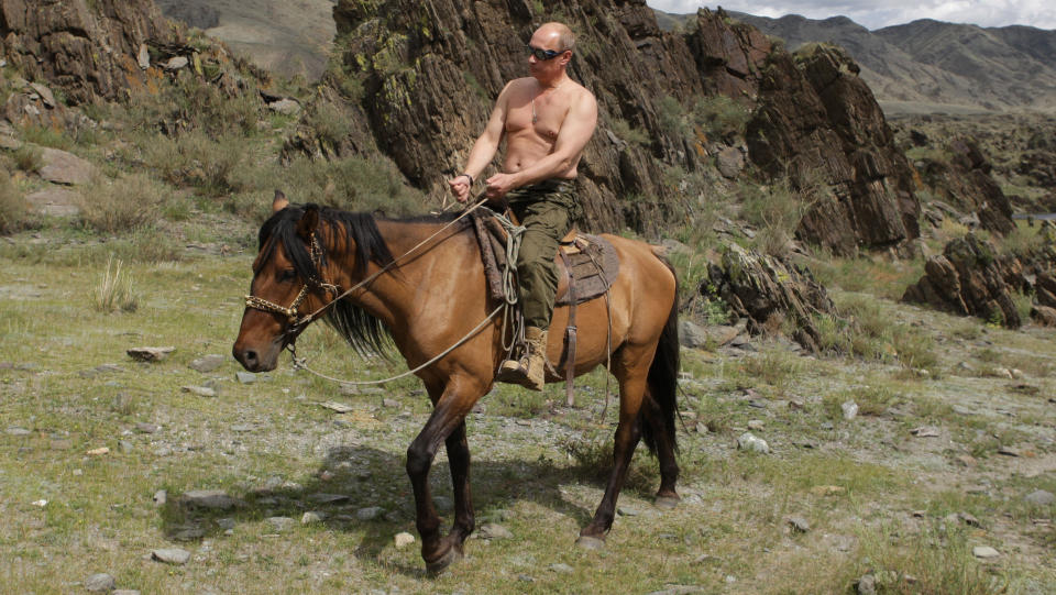 FILE - In this file photo taken on Monday, Aug. 3, 2009, then Russian Prime Minister Vladimir Putin seen riding a horse while traveling in the mountains of the Siberian Tyva region (also referred to as Tuva),  Russia, during his short vacation.  Putin has become alternately notorious and beloved for an array of adventurous stunts, including posing with a tiger cub and riding a horse bare-chested. (AP Photo/RIA Novosti, Alexei Druzhinin, POOL, File)