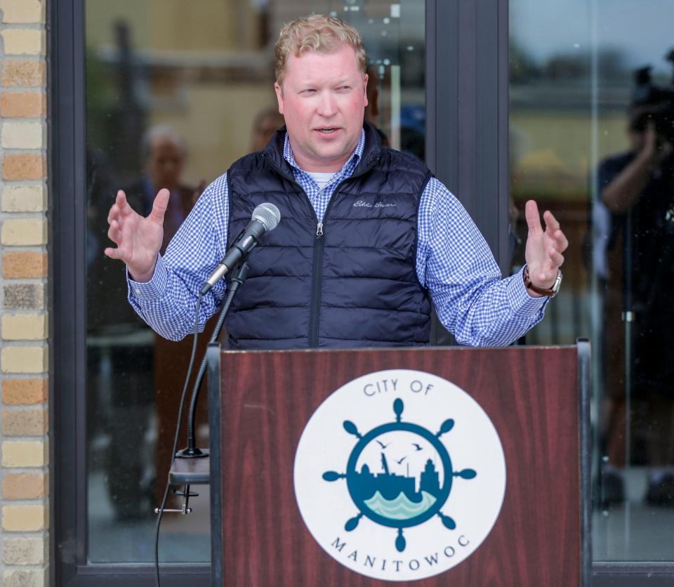 Manitowoc Mayor Justin Nickels explains how the public and private cooperation for the River North project came to before the ribbon cutting, Friday, May 12, 2023, in Manitowoc, Wis.