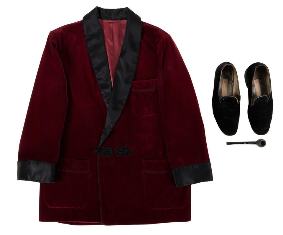 Hugh Hefner's burgundy smoking jacket, slippers and tobacco pipe were sold at the auction.