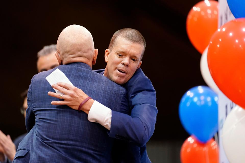 Tobin Anderson, right, Fairleigh Dickinson University men's basketball head coach, and Bradford Hurlbut, director of athletics, hug after a press conference on Thursday, May 5, 2022, in Hackensack.