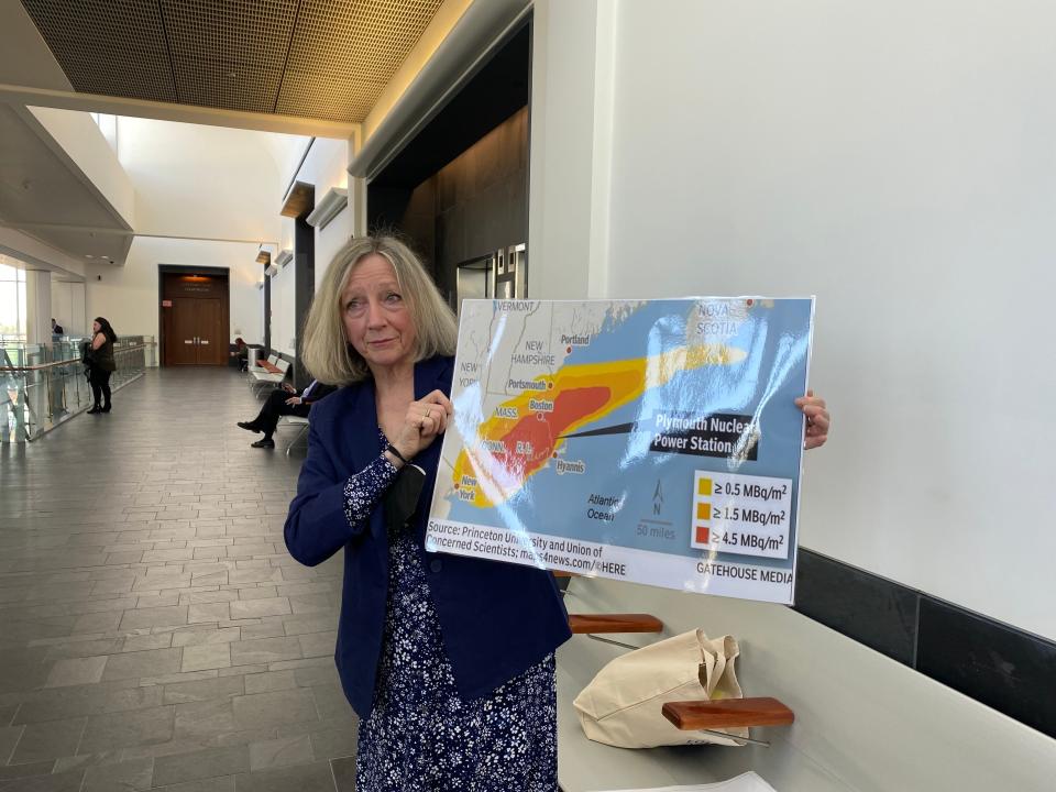 Diane Turco, pictured here after her trespassing case was dismissed, holds a 2018 map created by the Union of Concerned Scientists that shows what the potential impact of leakage from the Pilgrim Power Plant would look like. "All that red, that's a dead zone," Turco said.