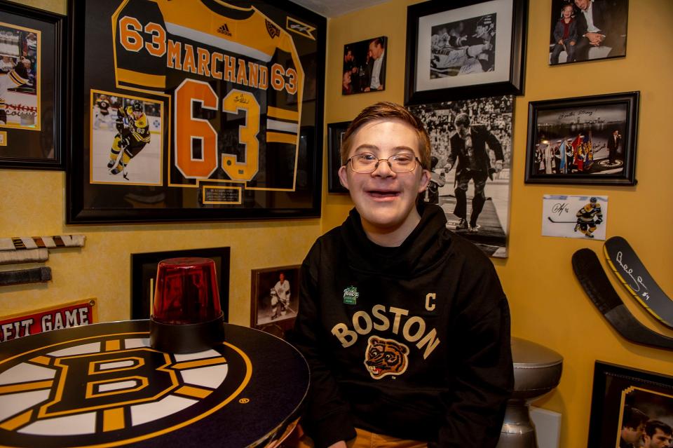 Liam Fitzgerald, 15, of Northborough, pictured in his sports-themed basement Dec. 29, 2022, will fist bump Bruins players at the Winter Classc at Fenway Park, Jan. 2, 2023.