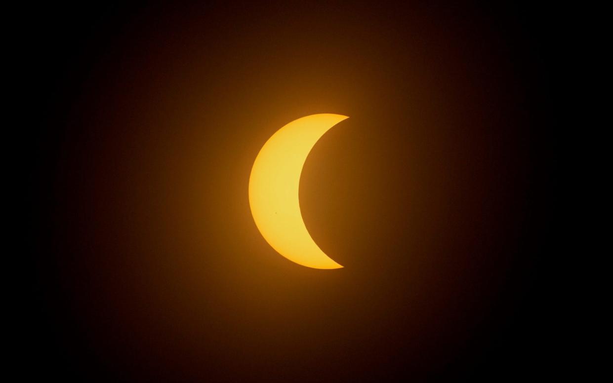 The moon partially covers the sun during a total solar eclipse in Mazatlan, Mexico