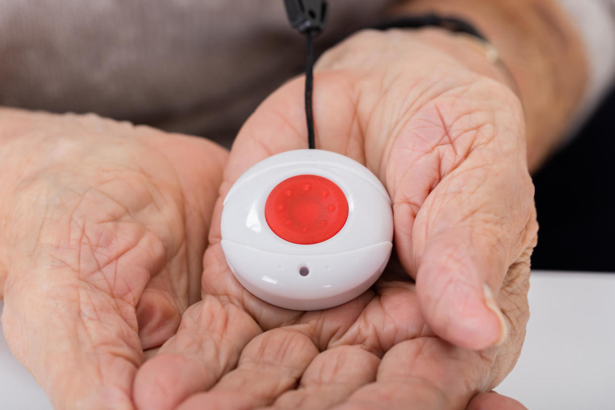 With the push of a button, a medical alert system can connect seniors to lifesaving care. But it comes with a cost. / Credit: Getty Images/iStockphoto