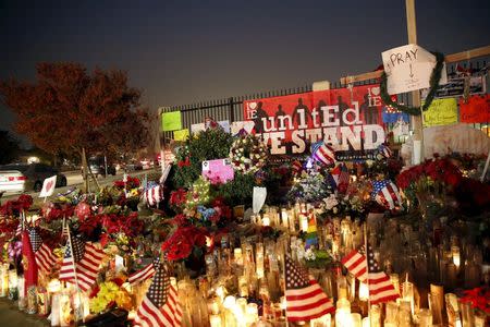 Flowers and candles are displayed at a makeshift memorial after last week's shooting in San Bernardino, California December 10, 2015. REUTERS/Patrick T. Fallon