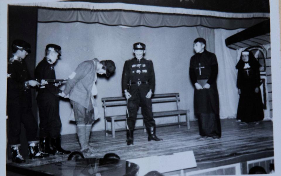 Yoshihide Suga (C) dressed as a policeman in a school play - REUTERS/Chris Gallagher