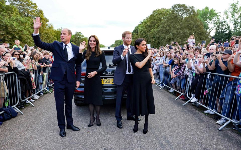 The Royals wave to the crowd after speaking to well-wishers on the Long walk at Windsor Castle