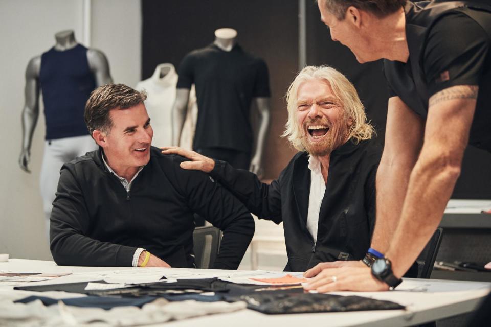 Under Armour CEO Kevin Plank and Virgin's Richard Branson are sitting at a table.