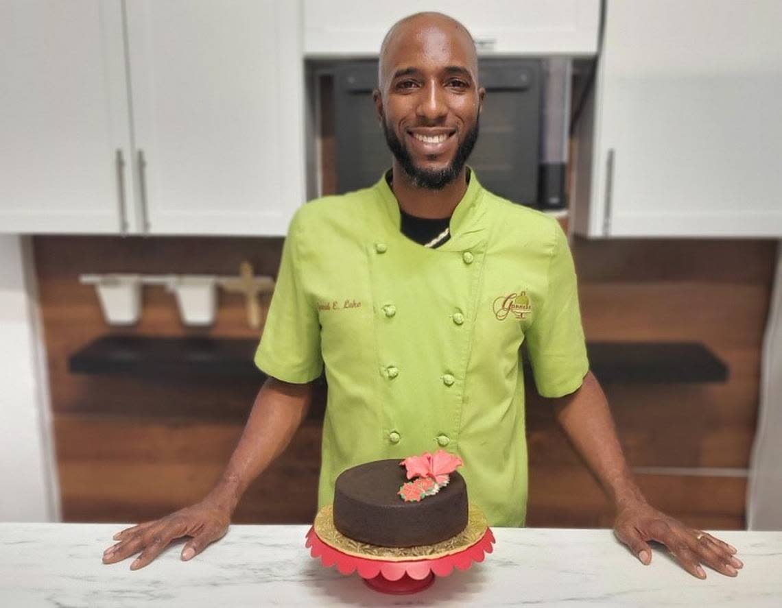 Jamal Lake of Ganache Bakery in West Palm Beach with one of his black cakes.