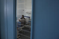 A Covid-19 patient sits on her bed at the COVID-19 ward of Amir Al-Momenin hospital in the city of Qom, some 80 miles (125 kilometers) south of the capital Tehran, Iran, Wednesday, Sept. 15, 2021. (AP Photo/Vahid Salemi)