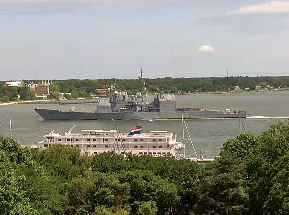 USS Leyte Gulf sails past another boat while arriving in Yorktown, Virginia.