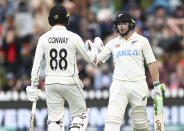 Tom Latham, right, and Devon Conway of New Zealand gesture on day three of the second cricket test between England and New Zealand at the Basin Reserve in Wellington, New Zealand, Sunday, Feb. 26, 2023. (Andrew Cornaga/Photosport via AP)