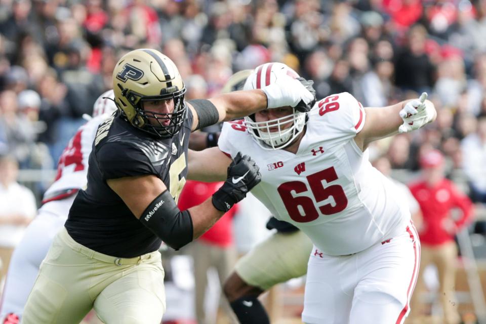 Purdue defensive end George Karlaftis (5) breaks free of Wisconsin offensive lineman Tyler Beach (65) during the first quarter of an NCAA college football game, Saturday, Oct. 23, 2021 at Ross-Ade Stadium in West Lafayette.