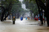 People go along flooded road after typhoon Damrey hits Vietnam in Hue city, Vietnam November 5, 2017. REUTERS/Kham