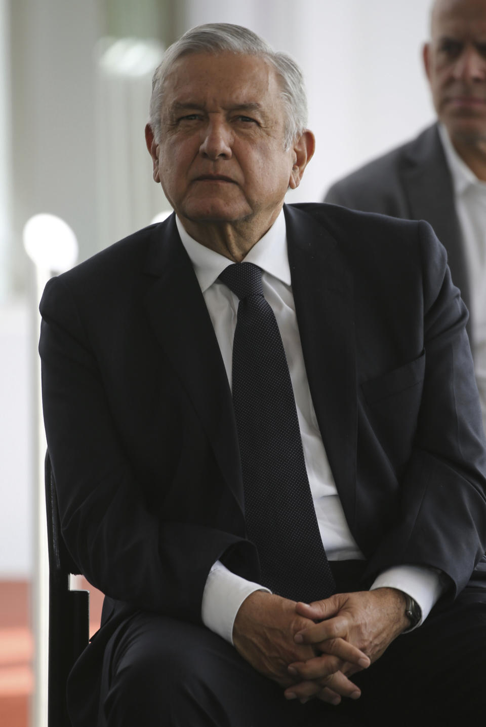 Mexico's President Andres Manuel Lopez Obrador waits to deliver a speech during his visit to a public hospital in Cuernavaca, Mexico, Friday, June 19, 2020. Lopez Obrador is desperate to restart Mexico's struggling economy after being cooped up under social distancing measures due to the new coronavirus pandemic. (AP Photo/Fernando Llano)