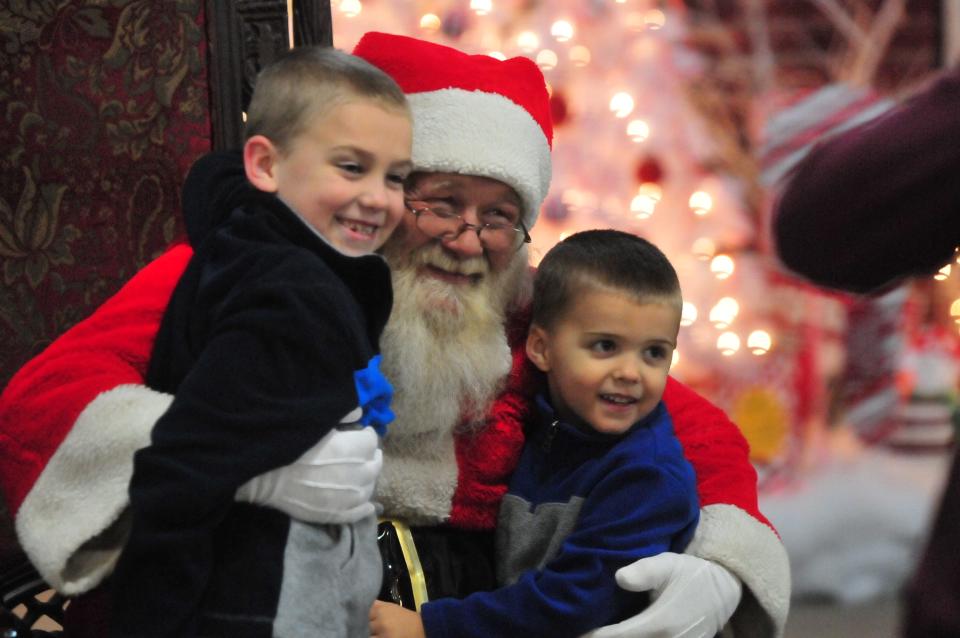 Children post for a picture with Santa at a past Old-Fashioned Christmas Festival.