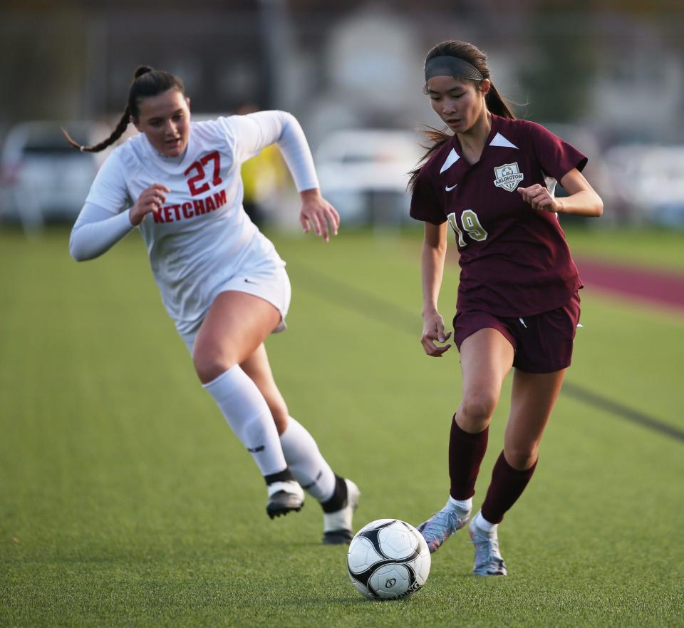 Arlington's Isabel Ren drives the ball upfield while chased by Ketcham's Kathryn Hotle during an Oct. 16, 2023 girls soccer game.