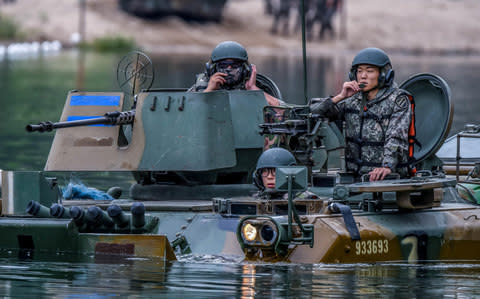South Korean Army's 11th Mechanized Infantry Division's K-200 armored vehicle takes part in a river-crossing drill in Hongcheon - Credit: Reuters