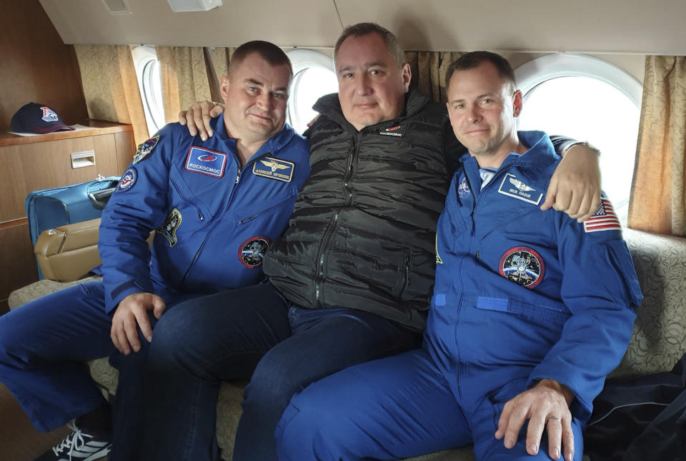 In this photo made available by Roscosmos on Friday, Oct. 12. 2018, agency leader Dmitry Rogozin, center, embraces cosmonaut Alexei Ovchinin, left, and U.S. astronaut Nick Hague at Star City, Russia, a space training center outside Moscow. After an aborted launch on Thursday, Rogozin promised that Hague and Ovchinin will be given another chance soon to work on the International Space Station. (Roscosmos via AP)