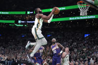 Boston Celtics guard Jaylen Brown (7) drives to the basket against Phoenix Suns forward Royce O'Neale (00) during the first half of an NBA basketball game, Thursday, March 14, 2024, in Boston. (AP Photo/Charles Krupa)